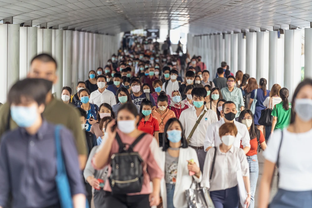 Crowd in public transport wearing masks